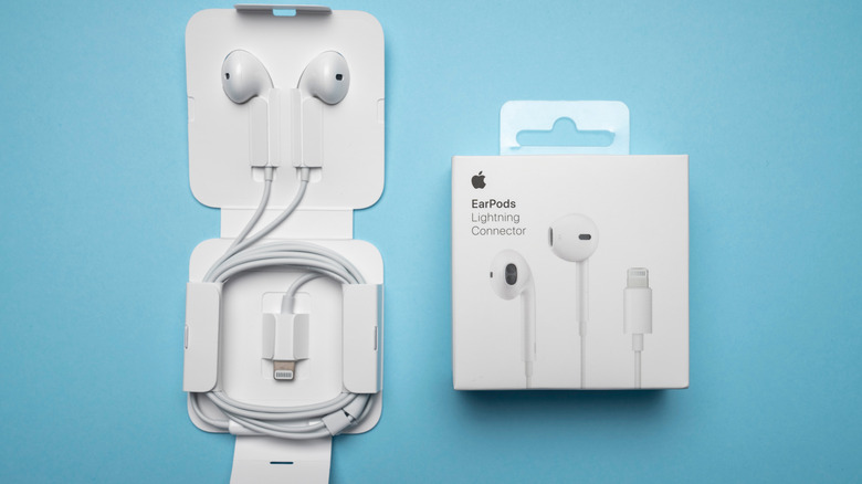 The box of Apple EarPods alongside an iPhone.