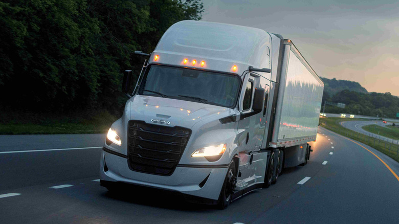 White Freightliner Cascadia semi-truck on the road
