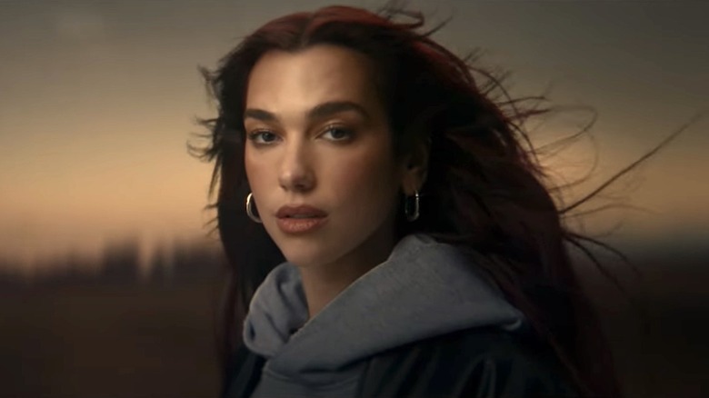 Dua Lipa appearing in a Porsche commercial