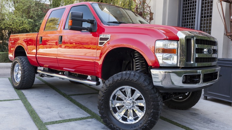 A red Ford F-250 Super Duty with a 6.4L Power Stroke diesel engine