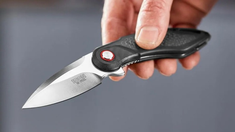 Harbor Freight's Icon drop point knife held by a man's hand.