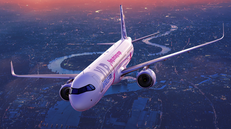 An A321 XLR flying over a city