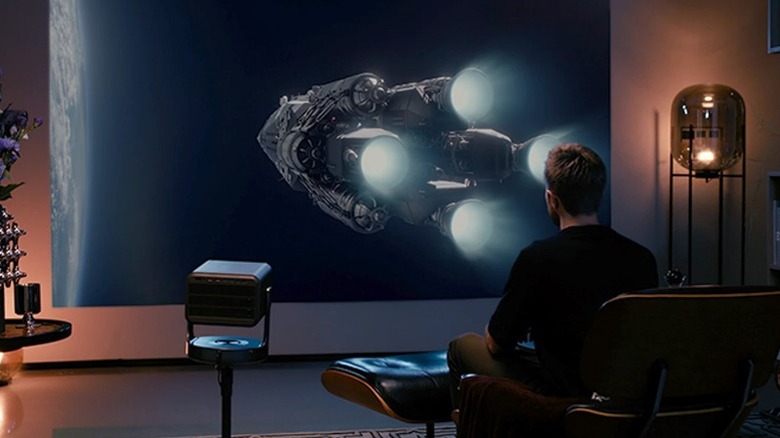 Hisense C2 Ultra on stand projecting sci-fi film