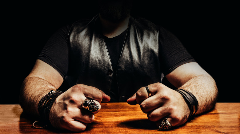 Motorcycle club member sitting in an interrogation room