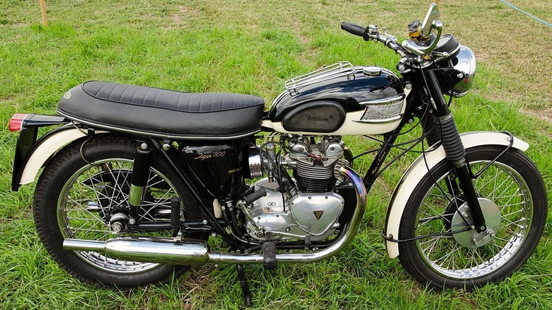 A Triumph Tiger motorcycle on grass.
