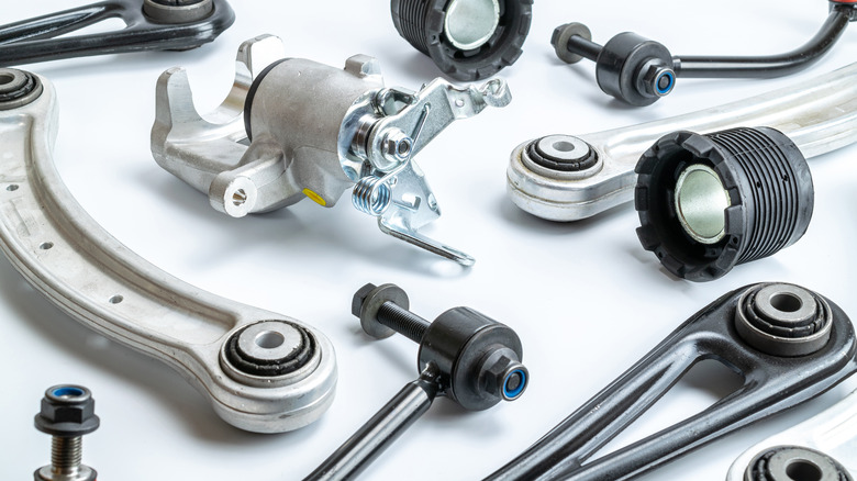 An assortment of new car parts on a white surface.