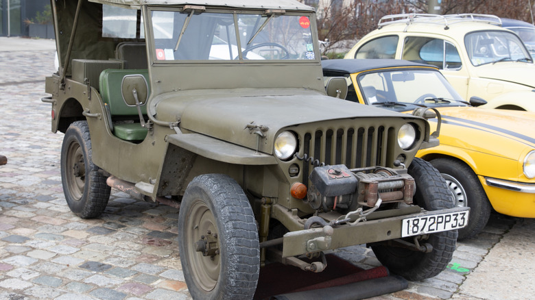A World War II era Jeep parked outside.