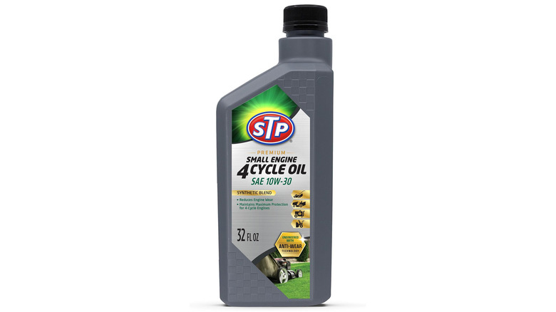 Bottle of STP 10W-30 oil on plain background