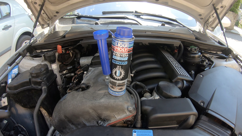 Fuel Injector Cleaner sitting atop a car engine