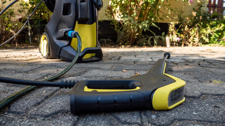 Pressure washer laying on pavement
