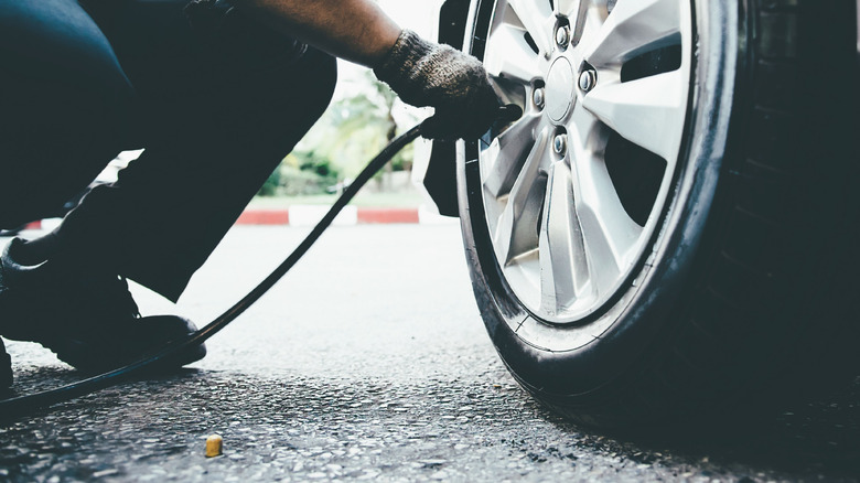 Man inflating car tire