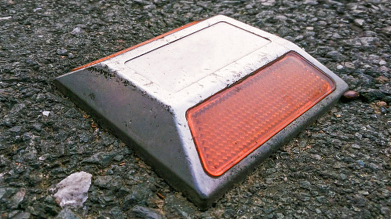 A closeup of a red road reflector