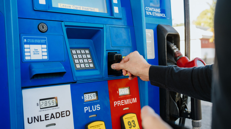 Person paying for gas at the gas pump
