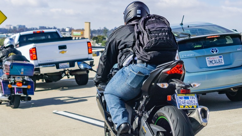 Motorcyclists riding through traffic
