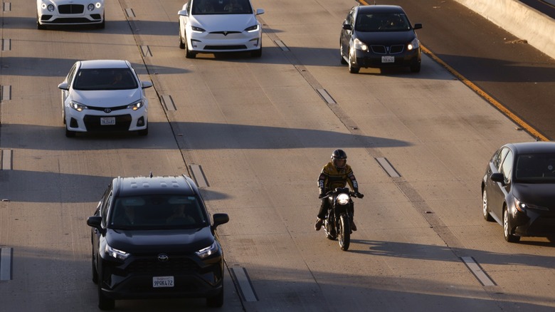 Motorcyclist riding through heavy traffic