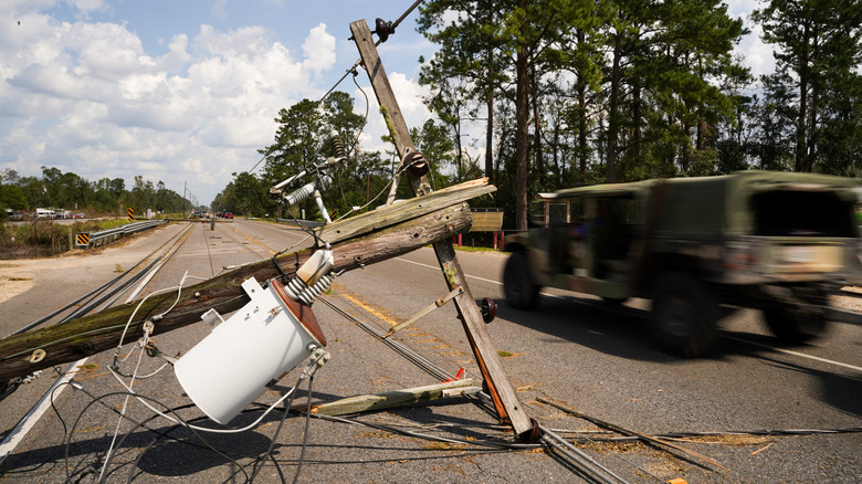 Truck drives past a downed power line