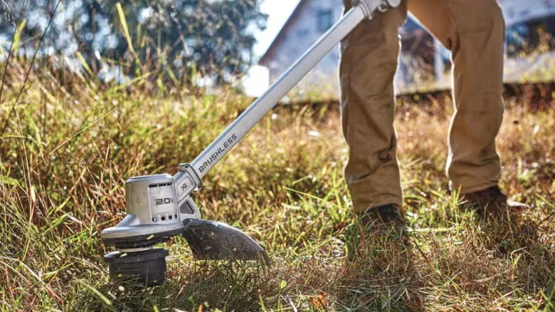 Person using DeWalt String Trimmer