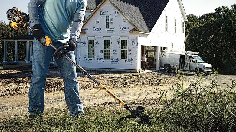 Person using DeWalt String Trimmer