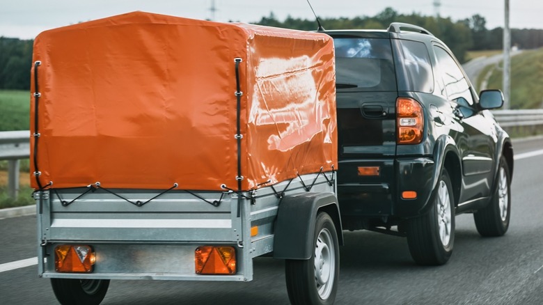 car pulling orange trailer