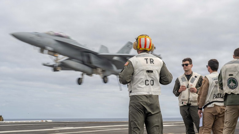 An F/A-18 Super Hornet coming in for a landing on the USS Theodore Roosevelt