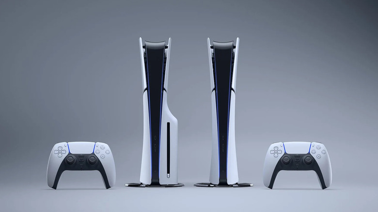 Two upright PlayStation 5 consoles and controllers.