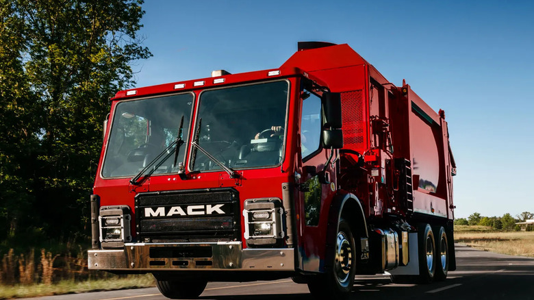 Front view of a red Mack LR refuse truck