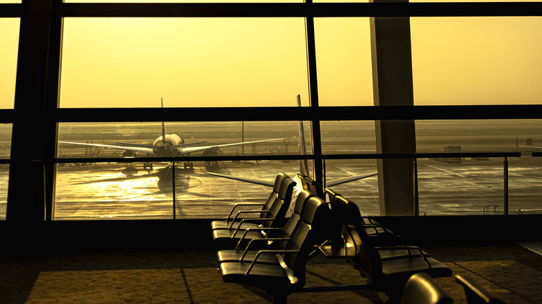 An empty airport terminal at sunset.