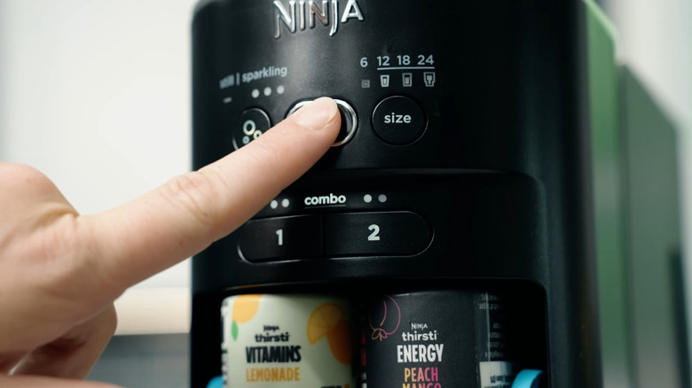 Finger pushing Start button on Ninja Thirsti
