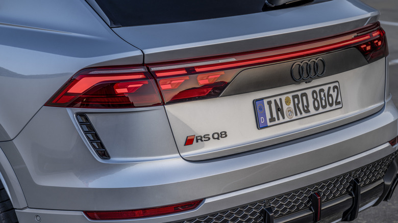 The rear of a silver Audi RSQ8 in silver, close-up shot showing the badge