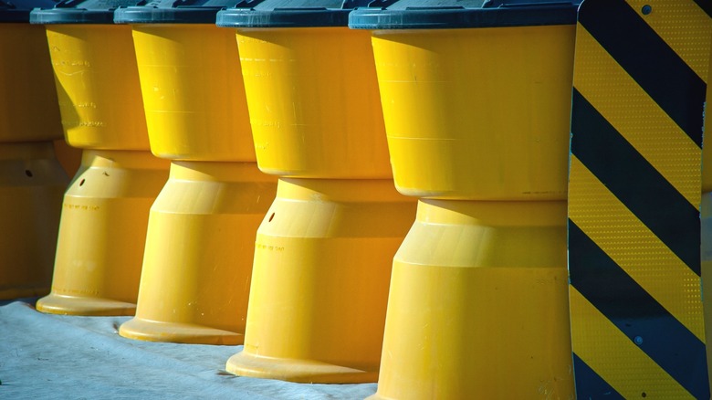 Close-up of yellow crash barrels.