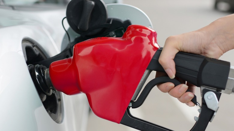 A red fuel hose inside a car's tank