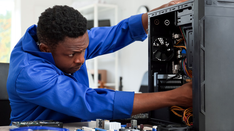 computer technician fixing a PC