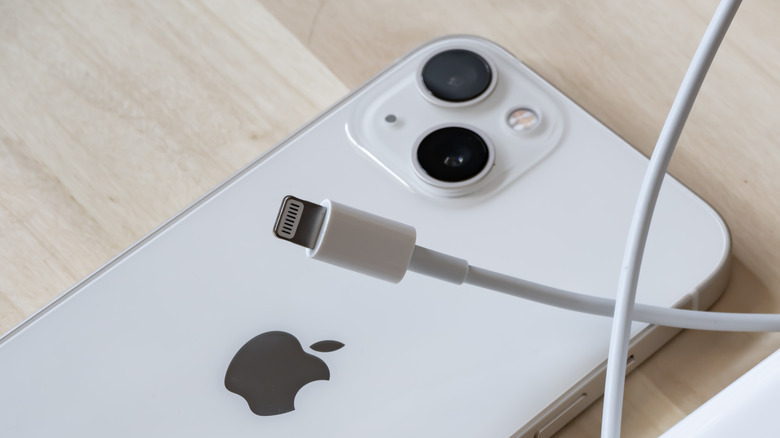 White iPhone with a charging cable