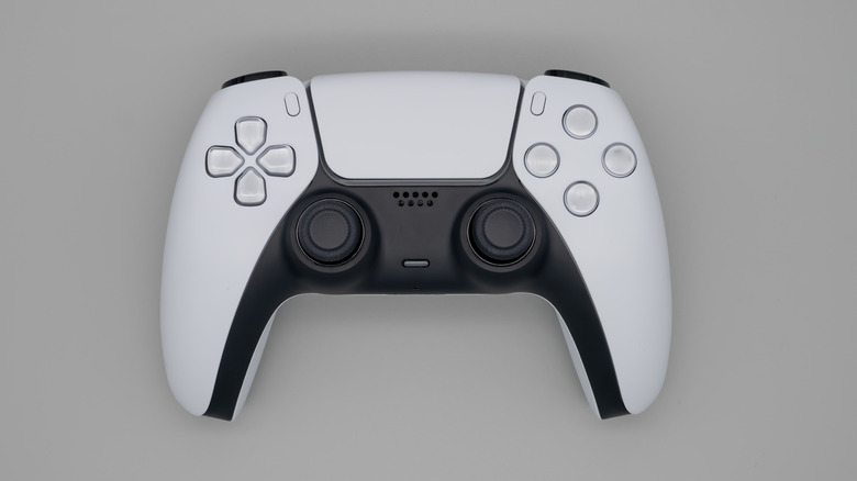 White gaming controller on gray surface