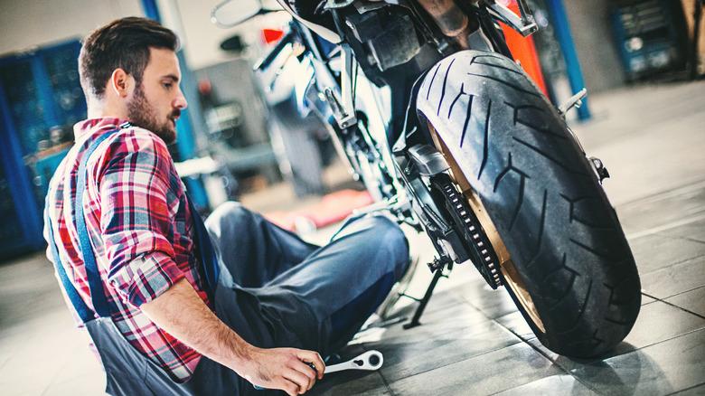 person working on motorcycle