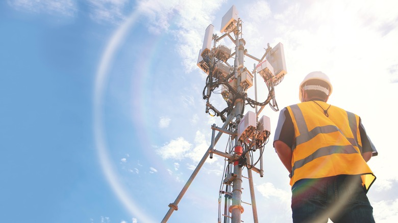 worker in front of cell tower