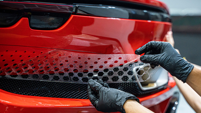 person installing PPF on car