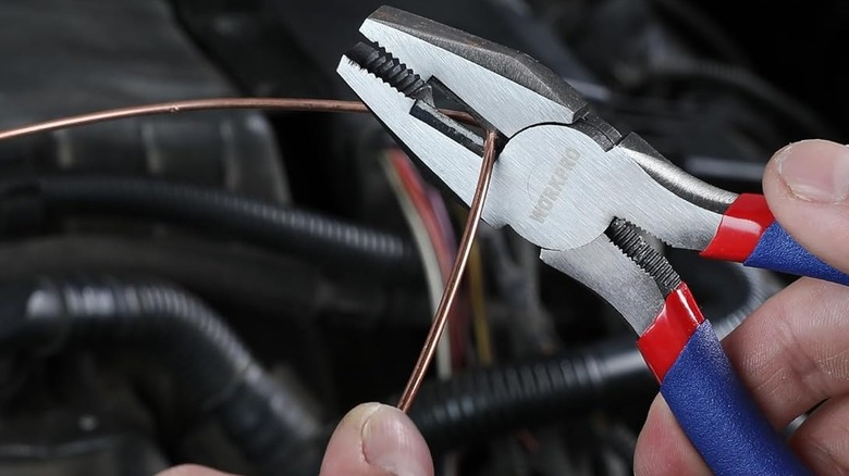person bending wire with pliers