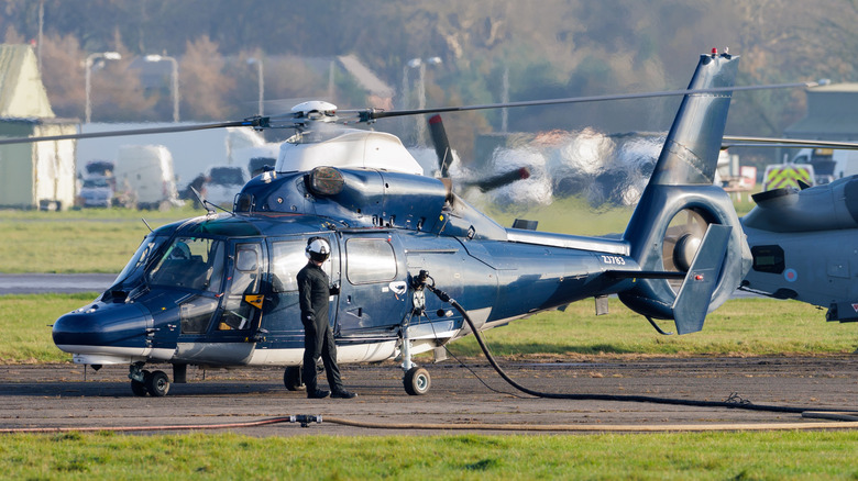 Blue and white helicopter in UK being refueled