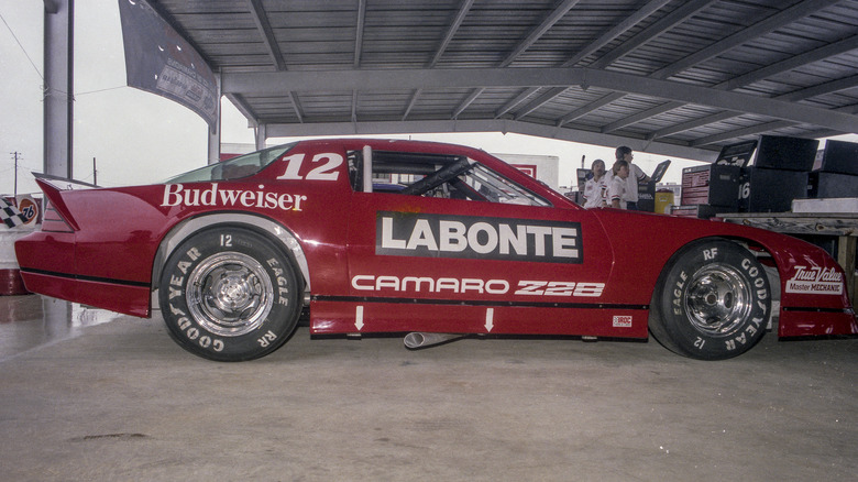 Red 1985 IROC Camaro race car in garage