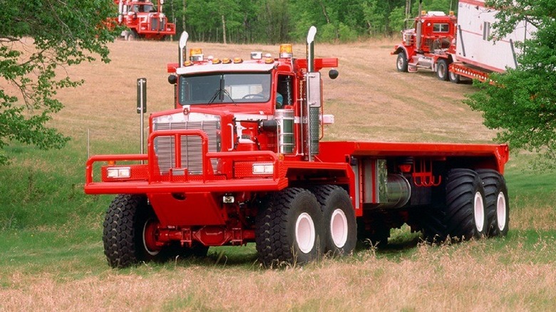 Kenworth C500 with twin-steer front axles, front 3/4 view, red exterior