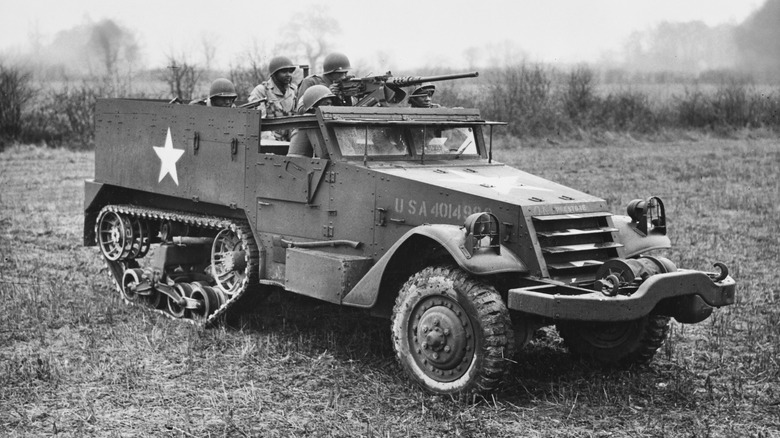 A group of soldiers on board an Army half track in WWII