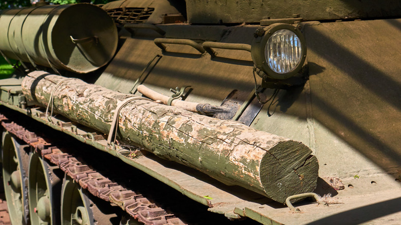 Close-up of a tank with a log mounted above the track