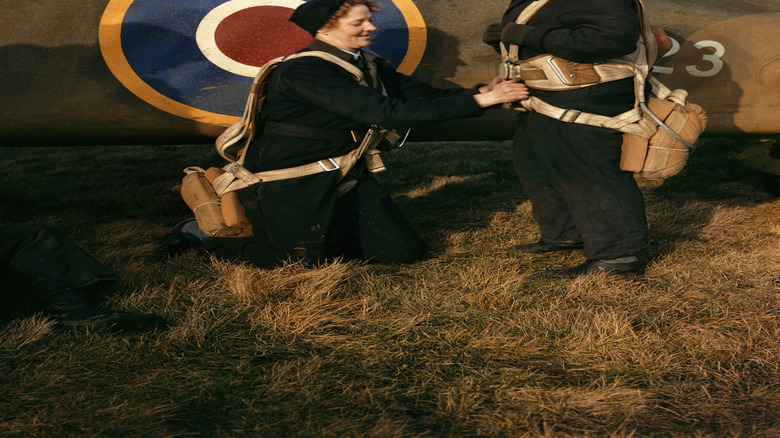 Two pilots standing in front of a plane roundel