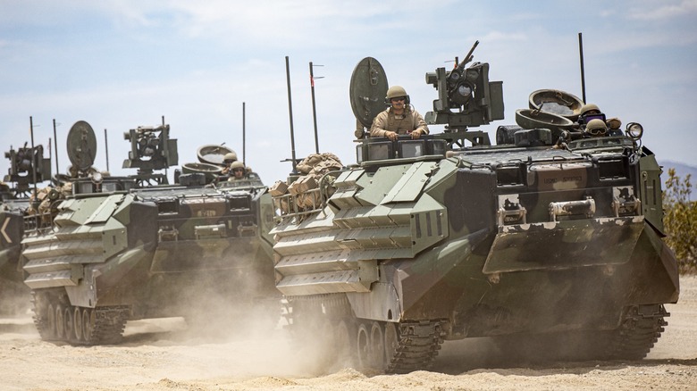 A trio of Amphibious Assault Vehicles operating on a beach