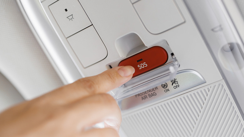 An image of a person pressing the car SOS button.
