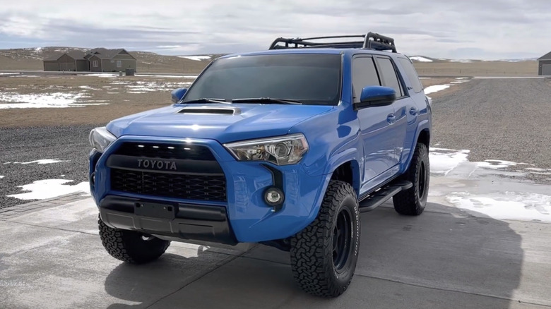 Front 3/4 shot of Vodoo Blue 2019 Toyota 4Runner TRD Pro parked in a driveway in snowy conditions.