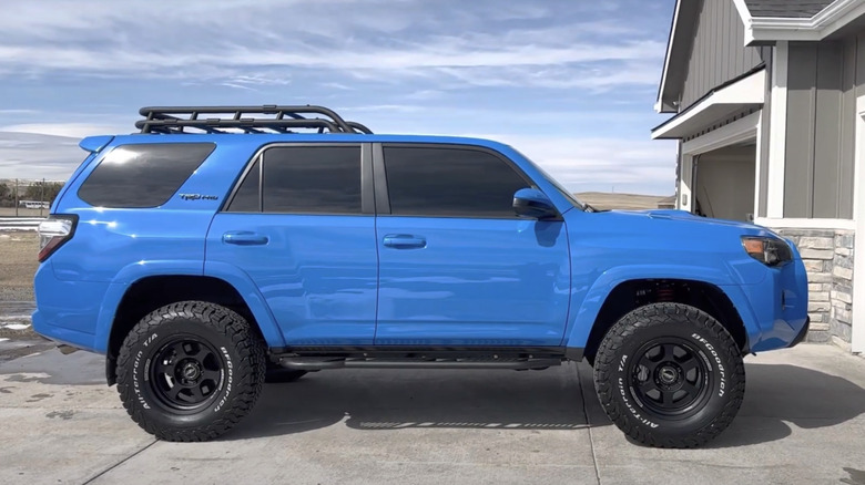 A side profile shot of a Vodoo Blue 2019 Toyota 4Runner TRD Pro parked in a driveway in snowy conditions.
