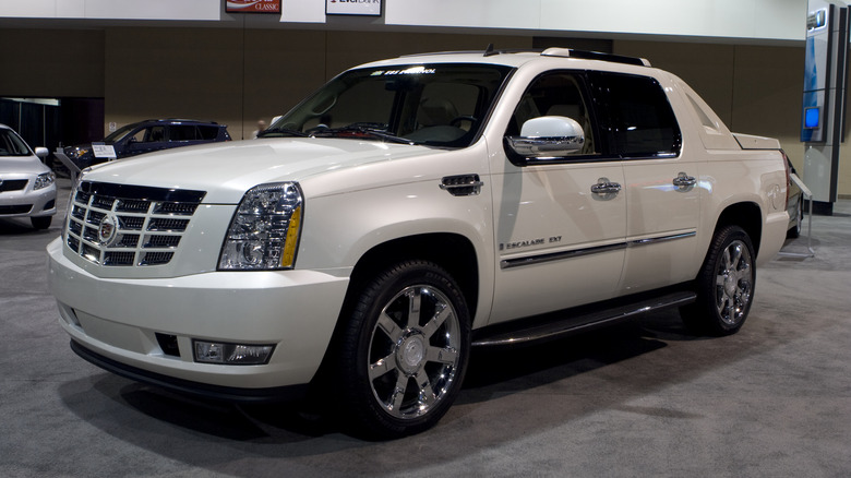 A white second generation Cadillac Escalade EXT, front 3/4 view