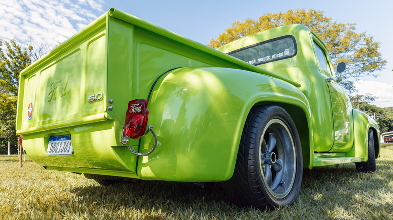 green Ford F-100 1961 model with a modified rear